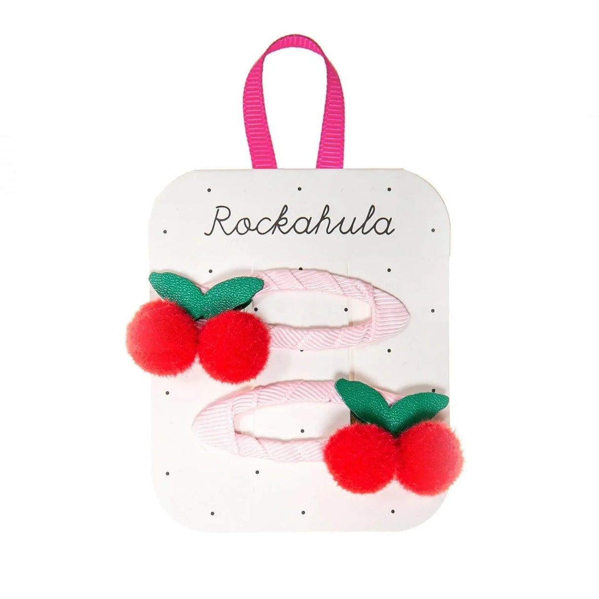 Zwei Kinder Haarspangen mit roten Kirsch-Pompons und grünen Blättern auf Kartenhalter.
